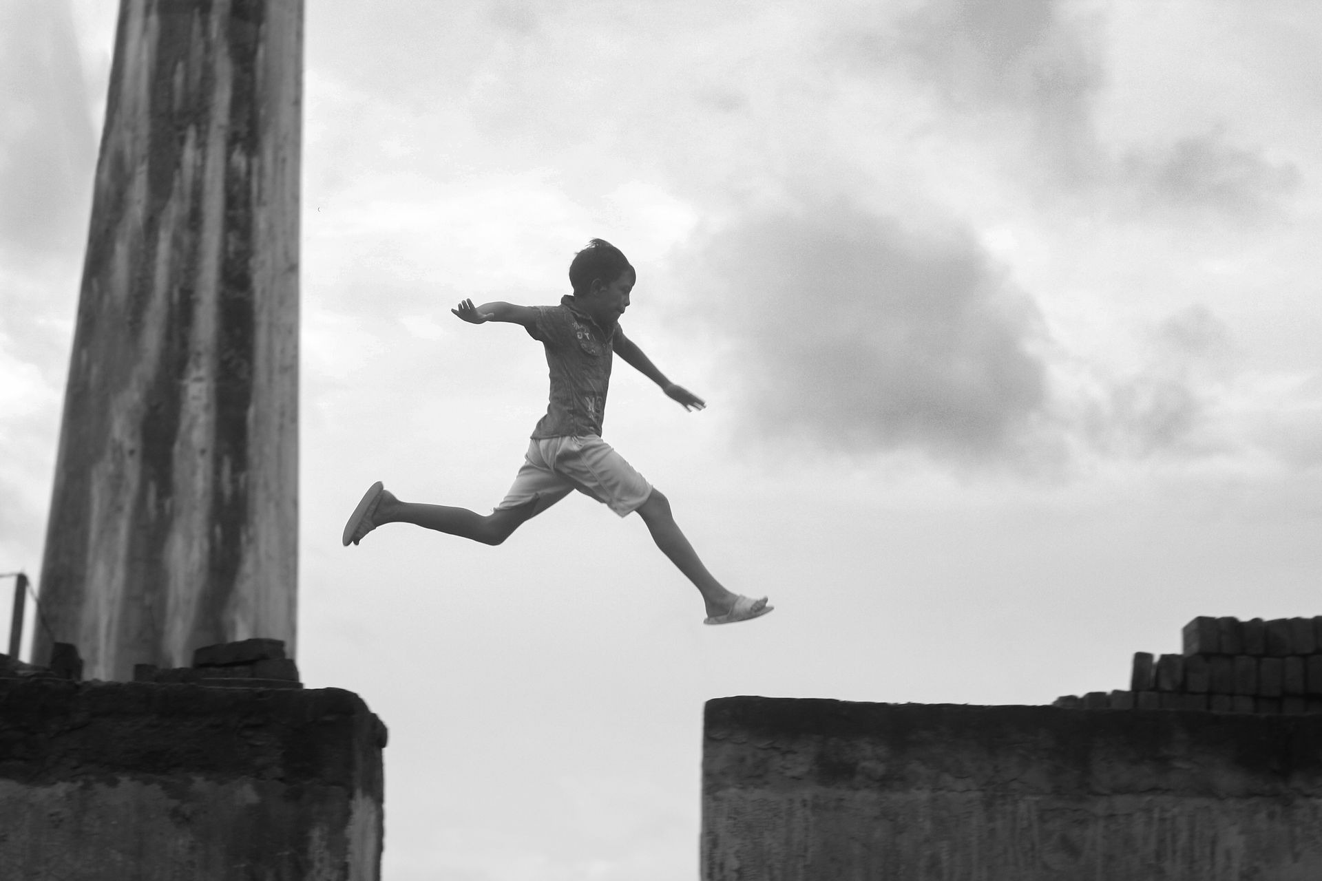 A child leaping across a gap, symbolizing courage and potential